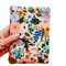 A hand holding a Kindle Paperwhite sleeve with snap to protect Kindle e-readers made with a pastel floral print atop a white background.